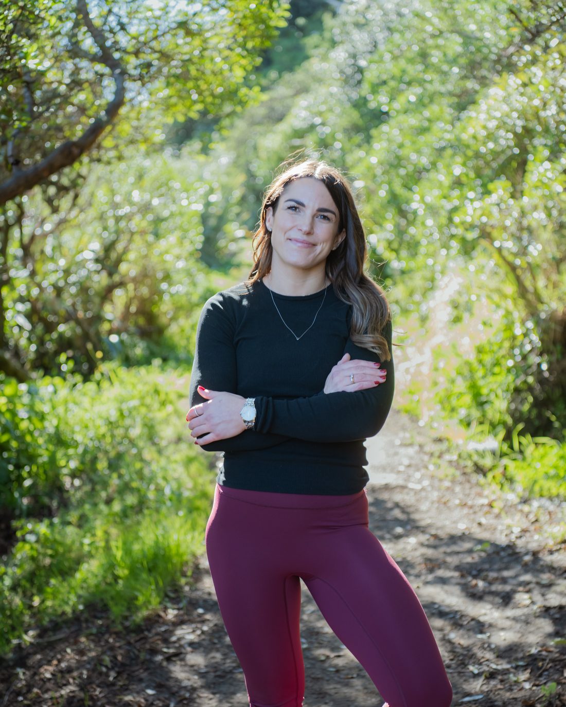 Jess Drayton standing on a bush track in dappled light